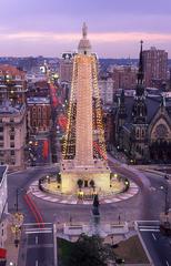 The towering George Washington Monument decorated with Christmas lights at Mount Vernon Place in Baltimore