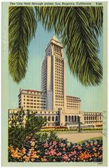 Los Angeles City Hall seen through palm trees on a sunny day