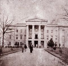 North Carolina State Capitol building in Raleigh with Governor David S. Reid in foreground, 1861