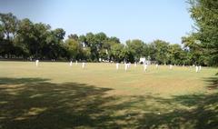 Football ground at Islamia College with clear sky and green field
