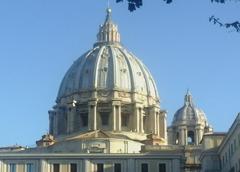 Exterior view of the Cupola di San Pietro in Vatican City under a blue sky