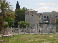 The Agora archaeological site in Athens with ancient Greek ruins and columns under a clear blue sky