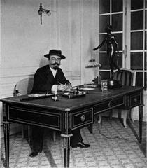 Portrait of Fernand Samuel, the director of Théâtre des Variétés, sitting in his office in 1900