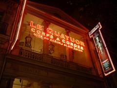 Neon signage advertising Le Quatuor on the Théâtre des Variétés in Paris, France