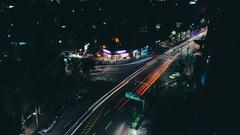 Dark neighborhood in Seoul at night with illuminated buildings and city lights