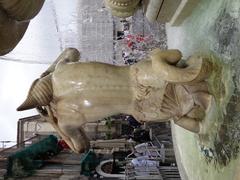 Close-up of the Triton statue on the left side of the Fontana dell'Amenano in Catania