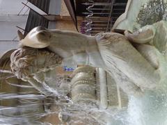 Close-up of the Triton statue on the left side of Fontana dell'Amenano in Catania