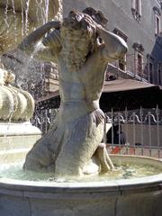 Right side triton sculpture of the Amenano Fountain in Catania, Italy