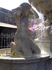 Tritone statue on the left side of Fontana dell'Amenano in Catania