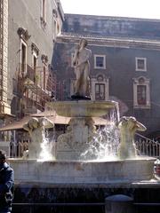 Fontana dell'Amenano in Catania with flowing water and vibrant greenery