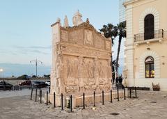Greek fountain in Gallipoli Italy with ornate stone sculptures and water basin