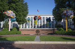 Northeastern University campus quad with students and greenery in spring 2024