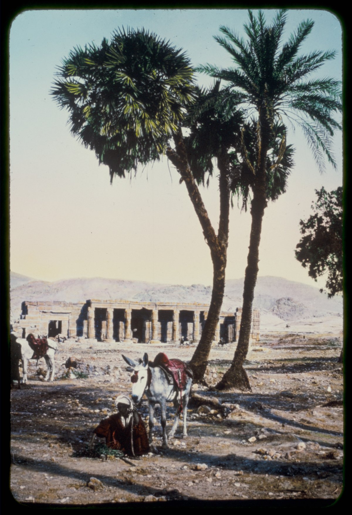 Temple of Kurna ruins in Thebes, Egypt with ancient stone pillars and hieroglyphs under blue sky