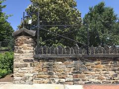 Close-up detail of historic stone wall at Greenmount Cemetery in Baltimore