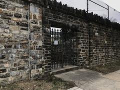 Locked gate facing East North Avenue at northeast corner of Greenmount Cemetery in Baltimore