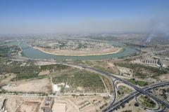 Tigris River flowing through Baghdad with cityscape and bridge