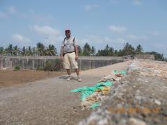 Seafarer Rudolph A Furtado exploring the rampart of Arnala Fort with intact fort walls and surrounding ruins