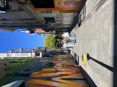 Jack Kerouac Alley sign with pink flowers and historic buildings in San Francisco in July 2022