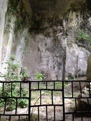 Ancient stone quarries with carved rock formations in Latomie dei Cappuccini, Siracusa