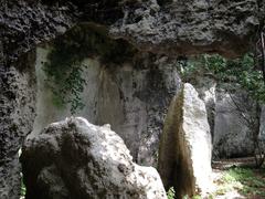 Latomie dei Cappuccini ancient stone quarries in Siracusa with rocky cliffs and greenery