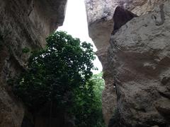 Latomie dei Cappuccini ancient stone quarries in Syracuse Italy with rugged rock formations and greenery