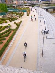 View of Puente de Toledo over Manzanares River in Madrid with surrounding greenery and cityscape