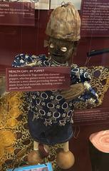 Hand manipulating puppet representing health care, displayed at Jimmy Carter Library and Museum