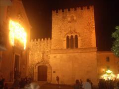 Corvaja Palace in Taormina, historic medieval building with stone facade and arched windows