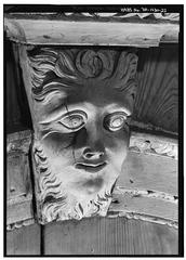 Close-up of a carved wooden mask with layers of paint removed on the tabernacle frame in Independence Hall's Central Hall