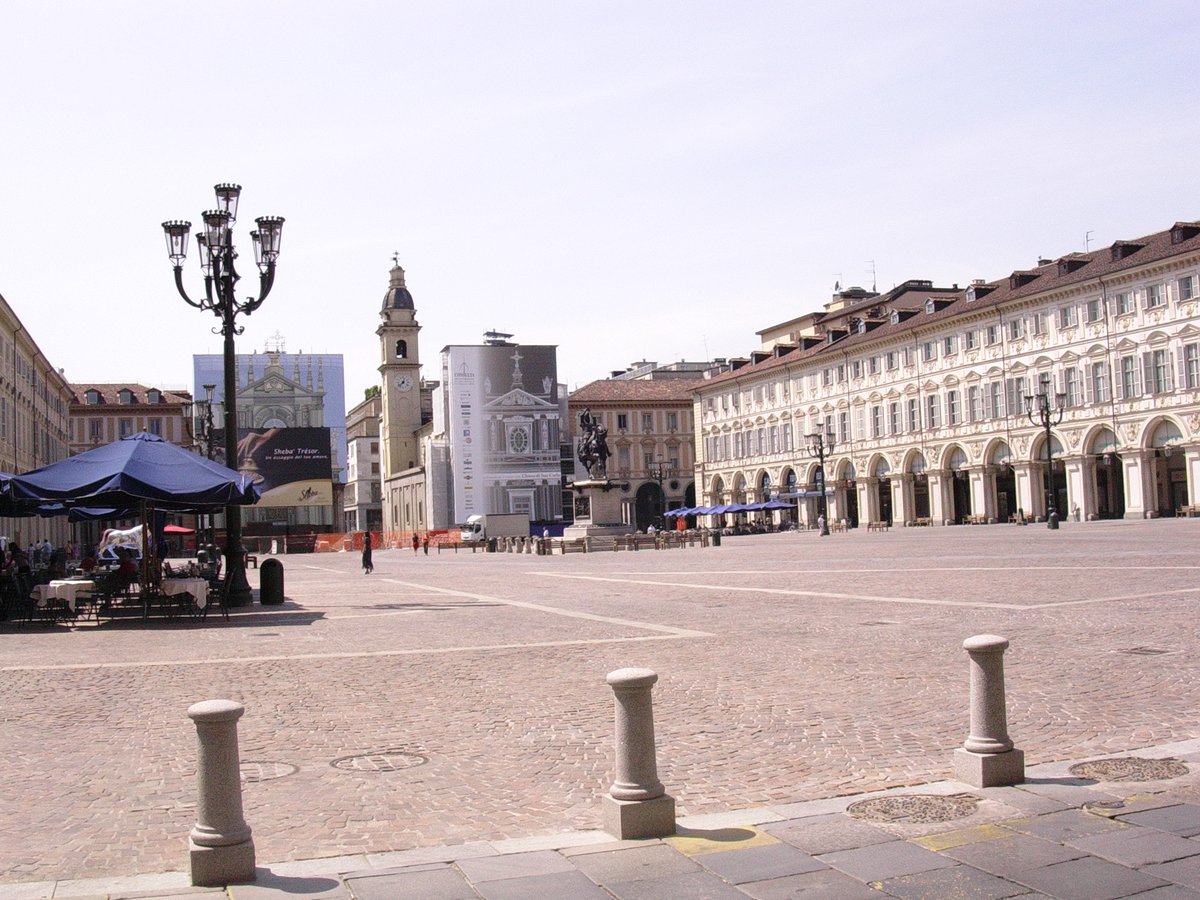 View of Piazza San Carlo in Turin with historic buildings and people walking