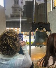 Visitor taking photos of the Liberty Bell at Independence National Historical Park in Pennsylvania