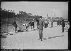 Sport fishermen competing in a fishing contest near Alexandre III Bridge on the Seine River in Paris, with a bugler playing in the background, August 27, 1922