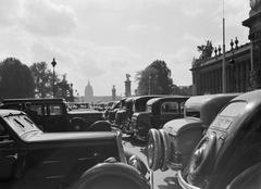 Vintage cars parked in front of the Grand Palais along Pont Alexandre III in Paris, 1935