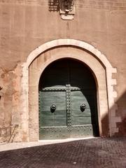 Porta San Pellegrino stone gate and fortress wall under a blue sky