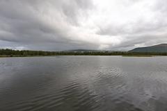 Scenic view of Prestvannet lake surrounded by autumn foliage in Tromsø