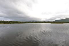 Scenic view of Prestvannet lake in Tromsø surrounded by autumn foliage