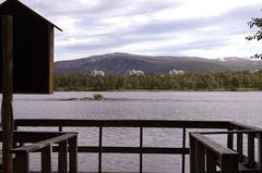 View of the observation pier at Prestvannet park with diverse birdlife and eastern view towards Myrengblokkene blocks in Tromsø