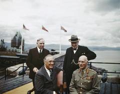 Group photograph of the First Quebec Conference in August 1943 on the terrace of the Citadel with Chateau Frontenac in the background, featuring President Roosevelt, the Earl of Athlone, Prime Minister Mackenzie-King, and Winston Churchill