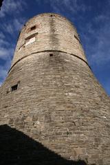 View of La Rocca fortress in Bergamo with stone walls and historic buildings under a blue sky