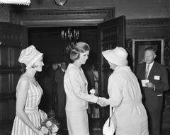 Queen Juliana presenting the Golden Cotton Boll award to winner Helen Jubels flanked by mannequin Rik Weyburg at the Royal Tropical Institute Amsterdam in 1960