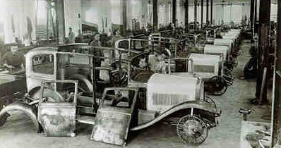 Early 20th century Alfa Romeo Portello factory interior with industrial machinery and workers