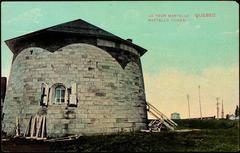 Martello Tower in Quebec City with stone structure and Canadian flags