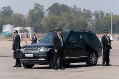 Security personnel surrounding the official vehicle of Indian Prime Minister Narendra Modi at Sardar Vallabhbhai Patel International Airport awaiting Donald J. Trump and Melania Trump arrival