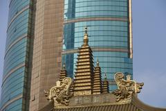 Jing'an Temple in Shanghai, China with traditional Chinese architecture and a modern cityscape in the background
