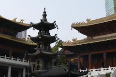 Jing'an Temple in Shanghai China with traditional architecture and red lanterns on a cloudy day