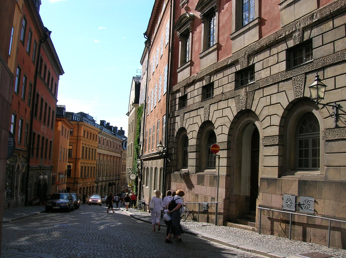 Storkyrkobrinken street in Gamla stan, Stockholm with historic buildings and cobblestone road