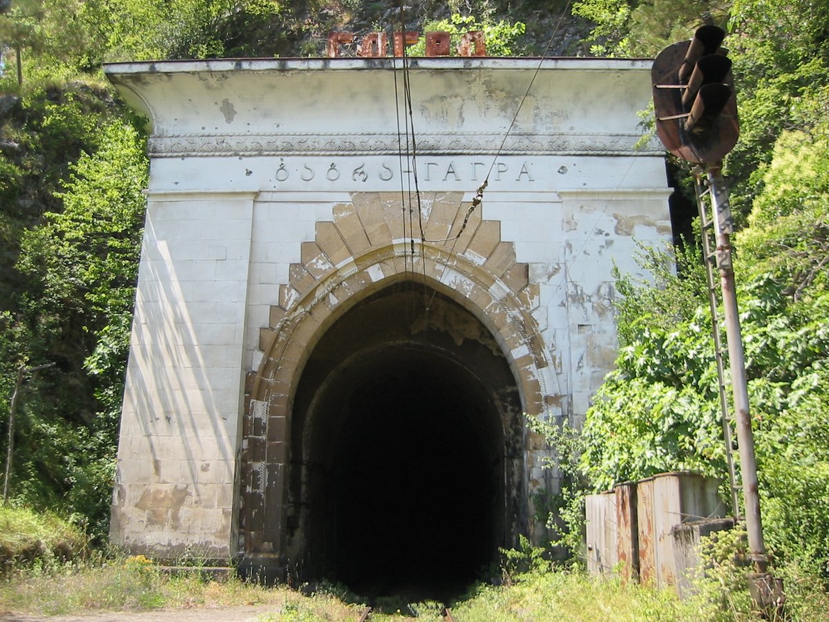Abaata train tunnel in Gagra, Georgia surrounded by lush greenery