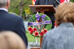 Beechwood Cemetery's 20th Anniversary Ceremony Honoring the Victims of 9-11 with attendees and floral tributes