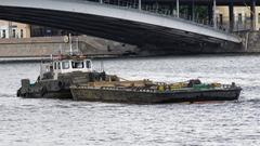 Moscow Jupiter tugboat pushing a barge on a river