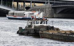Jupiter tugboat with barge on Moskva River in Moscow